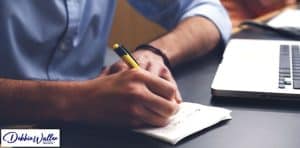 man listing new year resolutions