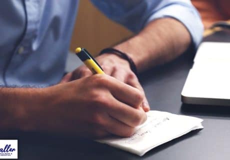 man listing new year resolutions