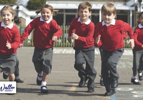 children running across a school playground to illustrate an article about a stress free start to the school year