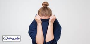 woman pulling her jumper over her face to illustrate an article on the fear of failure