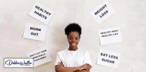 a woman surrounded by reminder notes about changing habits to illustrate an article on breaking an unwanted habit