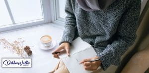 woman writing in a diary to illustrate an article on journaling for mental health