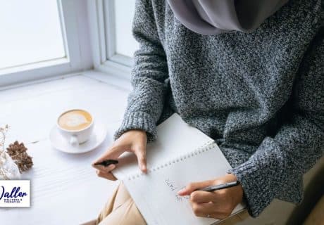 woman writing in a diary to illustrate an article on journaling for mental health