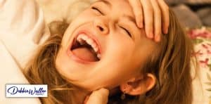 woman laughing to illustrate an article on the effect of laughter on mental health