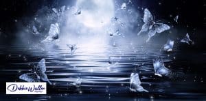 fantasy image of butterflies against the moon to illustrate an article on lucid dreaming