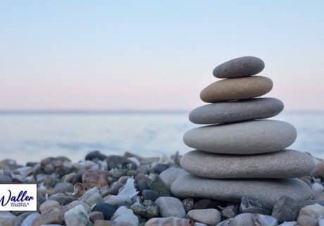 image of a seaside with stacked pebbles to illustrate an article on self hypnosis