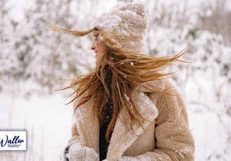 image of a woman in snow to illustrate an article on winter wellness