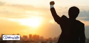 image of man triumphantly raising his fist to illustrate an article on how to stop a fear of success