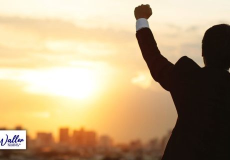 image of man triumphantly raising his fist to illustrate an article on how to stop a fear of success