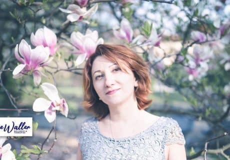 picture of a smiling woman against flowers to illustrate an article on menopause and anxiety