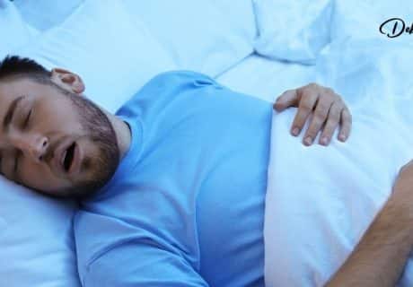 A man fast asleep and enjoying good rest.